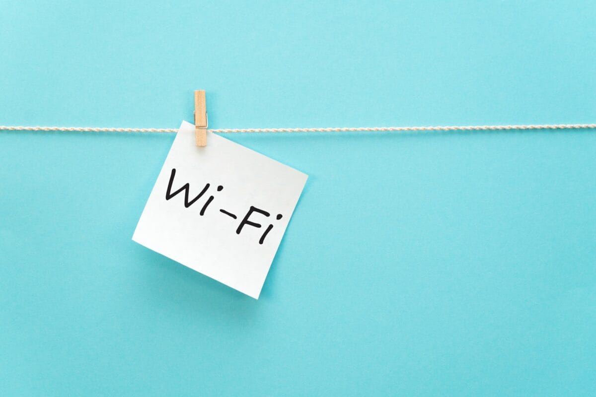 sticker with the inscription Wi-Fi hangs with a clothespin on a rope on a blue background